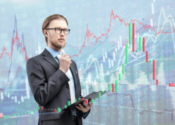 businessman trader analyst in glasses spectacles with notebook and thinking, on diagram background. Trading on stock exchange concept